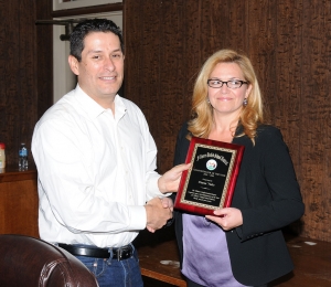 Schoolboard member John Garnica presents Piru Elementary School Principal Diana Vides with the Administrator of the Year award.