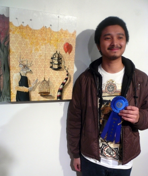 Winner Aaron Dadacy in front of his winning piece “Slaughter House”