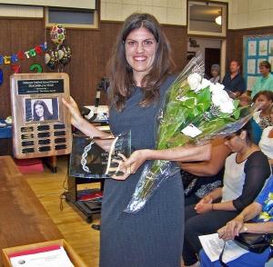 Laura Todis displays the award she received at Tuesday night's School Board meeting.