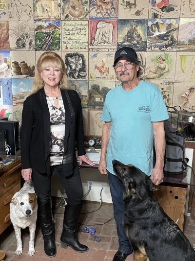Above are Alma and Max Gabaldon and their dogs Jake, left, a Queensland Heeler mix and Keyonno, a German Shepherd, in front of the Artists’ Wall. Photo credit Carina Monica Montoya. 