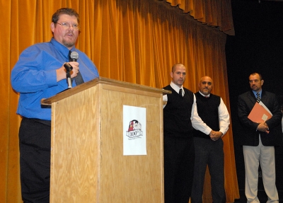 Coach Matt Dollar spoke to the audience about the history of the game in his family. To his left is Santa Paula Head Coach Teohua Sanchez and Santa Paula Principal Paul Marietti.