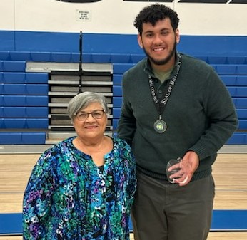 Fillmore High School graduating senior Eugenio Serna is the recipient of the 2023 Rosie Torres Scholarship For Future Teachers. Torres, a retired Fillmore teacher and long-time school volunteer, recently presented the award at an on-campus ceremony along with members of her family.