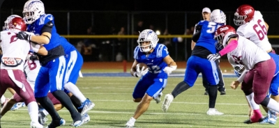 Pictured is Flashes number #22 carrying the ball as he looks ahead to fellow Flashes for a clear route for him to advance. Photo credit Crystal Gurrola. 