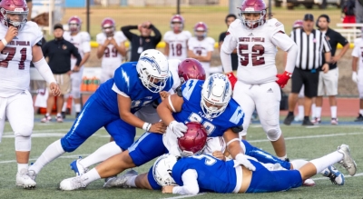Pictured above are Flashes JV players taking down a Cardinal during Friday night’s game. Photo credit Crystal Gurrola. 