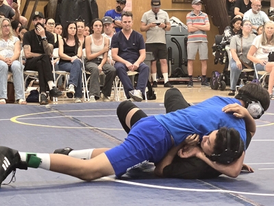 Pictured is FMS Bulldog Chris Padilla taking his opponent down during his match. Photo credit FMS Coach Michael Torres.