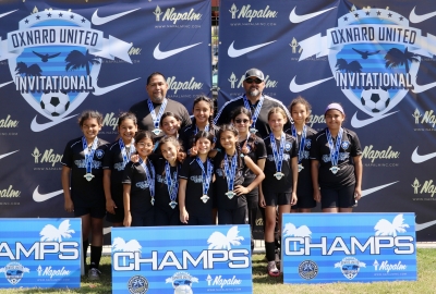 On July 12th-14th, Fillmore’s California United FC 2013 Girls teams competed at the Oxnard United Invitational. They showed well with multiple teams being named finalists, and the 2013 Girls team was Crowned Champions. Above are the 2013 Girls team receiving their medals. Coach Tony Mendez and Head Coach Jr. Lomeli, top (l-r): Sadie Manriquez, Sarahi Prado, Siani Lomeli, Bella Mendez, Aaliyah Cervantez, Hannah Sasson, Christine Beltran, and Kenya Hernandez; bottom (l-r): Mariana Arreola, Aixa Lomeli, Itzel Arana, and Toni Cervantez. Photo Credit Erika Arana (Public Relations), California United FC. 