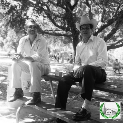 Can you identify the men on the picnic table?