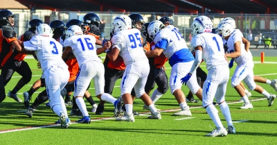 Pictured above is Flashes JV Offense trying to clear a path for a fellow teammate to break through the line. Photo credit Crystal Gurrola. 