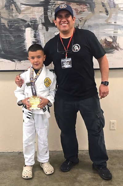 Above is Fillmore’s Dax Camacho with Coach Michael Torres. Dax claimed first place, and in No-gi he was equally dominant, winning all three of his matches securing another first-place finish and a true double-gold performance on the JJWL stage going 5-0 on the day. Photos by David Gonzalez & Diana Camacho.