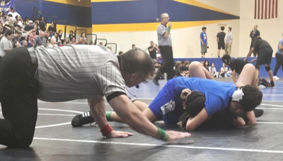 Above is the FMS Bulldog Christopher Padilla taking his opponent to the mat during his match on March 12. Photo credit Michael Torres & Cindy Vazquez.