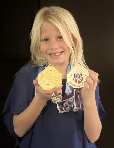Pictured above is Fillmore Condors Eva Dunlap and her awards. Photo credit Head Coach Kenny Leighton.