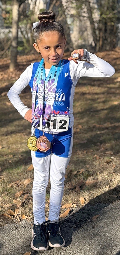 On Saturday, December 6, 2025, multiple local youth from the Fillmore Condors Youth Cross Country Club competed at the AAU National Cross Country Championships in Knoxville, Tennessee. Pictured is McKayla Magana with her medals. Photo credit Head Coach Kenny Leighton.