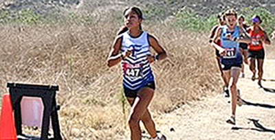 Leading, FHS Sophomore Melanie Martinez competes in the Scary Dairy Invite on September 5 near Cal State University Channel Islands. Martinez finished 11th with a time of 23:11.3 at the Dairy Invite.