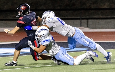 Above, two Flashes players team up to take down a Grace player during Friday night’s game. Fillmore defeated Grace 62–34. Photo credit Crystal Gurrola.
