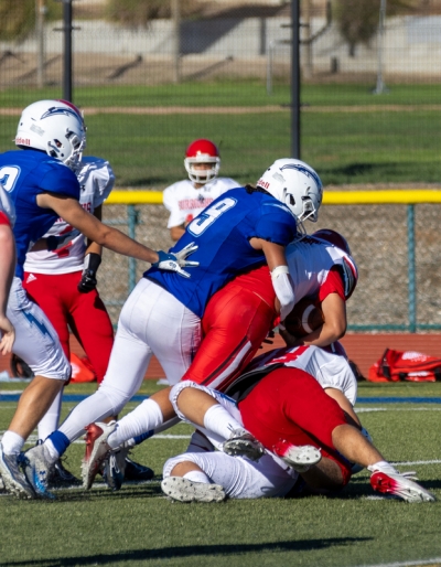 Flashes JV #9 as he makes a tackle to stop a Burroughs player from advancing in last Friday’s game. Photo courtesy Crystal Gurrola.