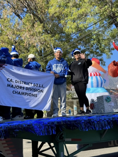 Pictured is Ralphy Avila, Jax’s son and a Fillmore Little League player, and Jax Avila, Fillmore Little League Board Member, riding in the 2023 Lions Club Christmas Parade. Photo credit Brandy Hollis.