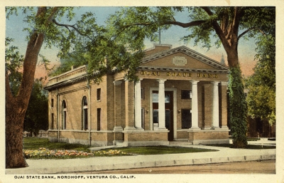 OJAI STATE BANK: This remarkable building, with its classical columns, was constructed in 1910 and retained that name until it was purchased by the Bank of Italy in 1927 (subsequently, the Bank of America).  Even while the businesses of the town of Nordhoff had the appearance of any frontier western town, with wooden false fronts, this elegant building stood facing them across the street.  It was razed in 1960.