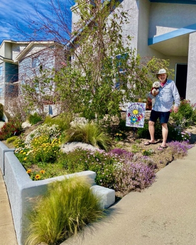 The Civic Pride volunteers announce Ray and Lupe
Hoover’s residence as the April “Yard of the Month.”
Pictured is Ray with his dog Chloe enjoying a beautiful
day in the yard, receiving the $50 gift certificate for Otto
& Sons Nursery. Photo credit Linda Nunes