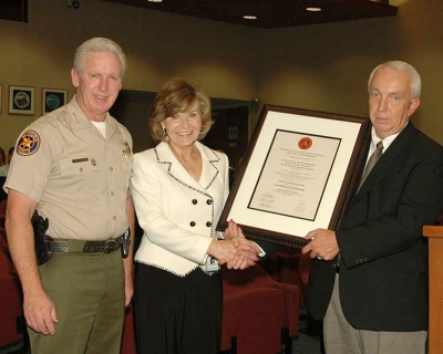 Left to right: Sheriff Bob Brooks, Renee Artman, and John Neuner