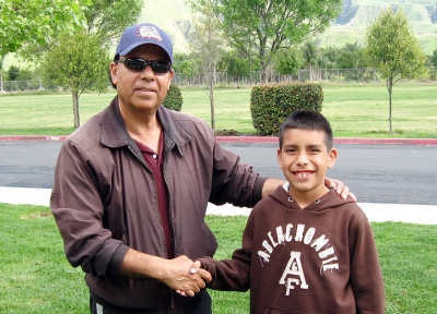 Mr. Alcozar and Luis share a smile and a handshake.