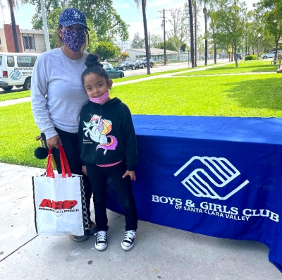 Rosie Perez and Cezalila Villanueva smiling with their bag of supplies.