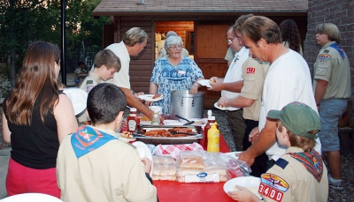 Marie Wren serves up her special camp chili to the hungry crowd.