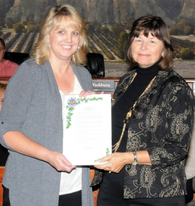 Leonore Young (left) received a proclamation from Mayor Gayle Washburn for her 22 years of service at city hall.