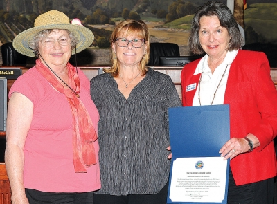 Picture is Mayor Diane McCall (center) presenting Joanne King (left) and Linda Nunez with a recognition of the Fillmore Flower Show, celebrating 100 years of showcasing flowers to the Fillmore community.