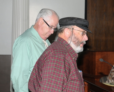 Steve Stewart and Tom Petersen introduce the Pilot Program to charge for portable toilet waste, during Tuesday night’s council meeting.