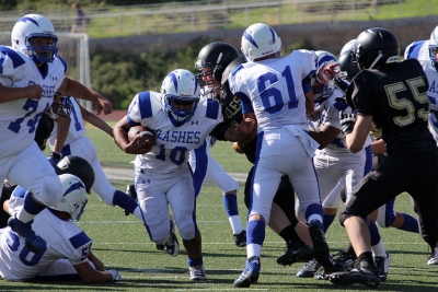 Daniel Tafoya rushes for a first down as 61 Cody Isaacs and 74 Brandon Castillo Lead the way.