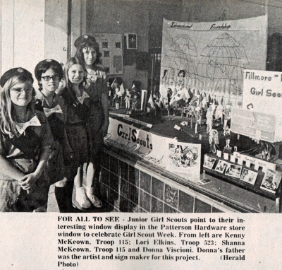 Article from the Fillmore Herald March 16th 1972 reading “The Junior Girl Scouts point to their interesting window display in the Patterson Hardware store window to celebrate Girl Scout Week. From left are Shanna KcKeown, Troop 115; Lori Elkins, Troop 523; Shanna KcKeown, Troop 115 and Donna Viscioni. Donna’s father was the artist and sign maker for this project. (Herald Photo).
