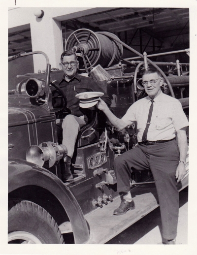 Fillmore’s George Palmer handing over the Fire Chief ’s hat to Oscar DeFever. Palmer was appointed assistant fire chief in 1940 and was elevated to city fire chief – a position he held until 1964. 