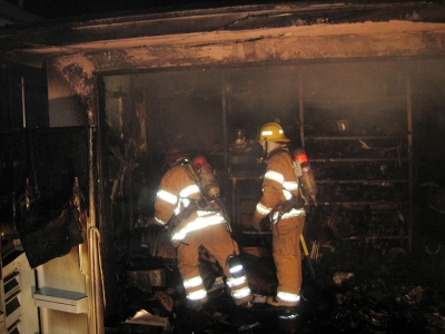 Fillmore Firefighters sift through the remains of a residential garage fire that occured early monday morning in the City of Fillmore. No injuries were reported at the fire was contained to the garage. The cause of the fire remains under investigation.