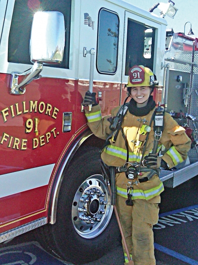 An unexpected provisional volunteer with a shiny giant toolbox on wheels, otherwise known as Engine 91. Note the discreet ax and balaclava styling. Photo Credit: Capt. Bill Herrera, FFD.