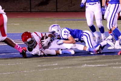 Varsity #19 Bryce Farrar makes a tackle