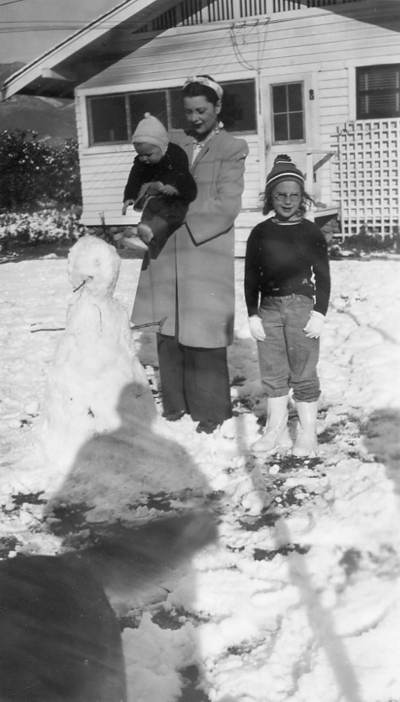 Snow in 1949: Elton's Son, Douglas, in the arms of Wife June and daughter Kathleen standing in front of 1462 Ventura Street
