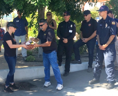 Fillmore Fire Chief Keith Gurrola presenting Iverson’s wife Ashley with a gift basket filled with Fillmore treats.