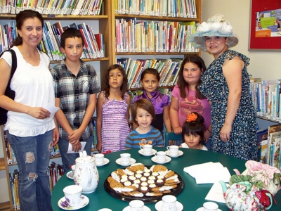 Renee Perez from Bella’s Teas and Treats (in hat) and Louisa Golson, adult left.