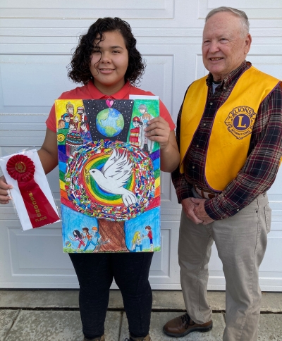Lion’s Club member Scott Lee with Maria Gallegas. Maria won runner-up award for the Lions Club Peace Poster Contest.