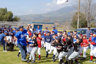 President David Lugo throws shirts to the Little League players during Saturday’s Opening Ceremonies.