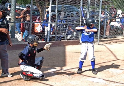 Piru held their opening ceremonies last Saturday. Above catcher Freddy Hurtado (Red Sox) and hitter Brendon Baker (Dodgers) show how it is done.
