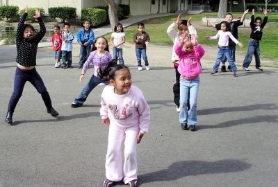Marlene Garcia, Jasmine Vasquez, Xochitl Ruiz, Yulizza Aguilar and Jovanny Figueroa lead the Kindergarteners in jumping jacks.