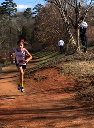 Paola Estrada on her way to becoming the National Champion in the 3000 meters 9 and 10-year-old girls race in Knoxville Tennessee this past Saturday. 