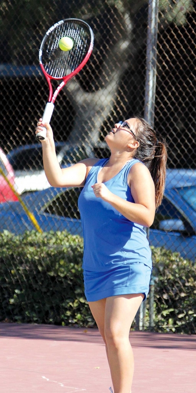 Karime Renteria serves to the opposing team.