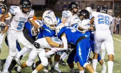 Pictured above is a group of Flashes taking down a Buena player to keep him from advancing up field. Inset, Flashes JV’s #2, making his way into the end zone, scoring a touchdown for the Flashes. Photo credit Crystal Gurrola. 