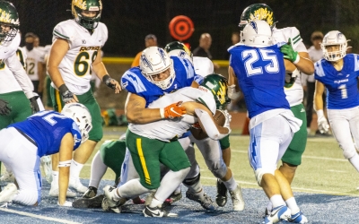 Pictured above is Flashes Varsity defense taking down a Simi Valley player to keep him from advancing. Photo credit Crystal Gurrola. See more photos online at www.FillmoreGazette.com. 