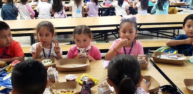 Students enjoying lunch and chatting with friends.