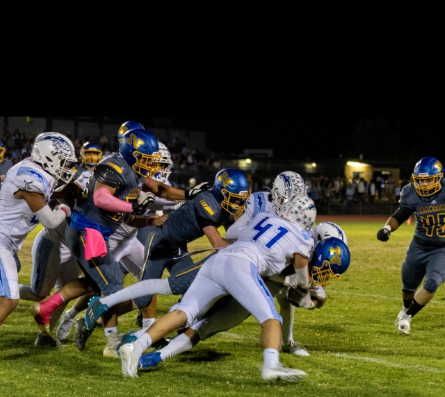 On Friday, October 13th, 2023, Fillmore took on Nordhoff High School and defeated them 35 – 7. This week Fillmore will be hosting their 2023 Homecoming Game on Friday, October 20th, against Carpinteria High School. JV begins at 4pm; Varsity at 7pm. JV score not reported at press time. Info courtesy: https://www.maxpreps.com/ca/fillmore/fillmore-flashes/football/. Above are a couple of Flashes Varsity players tackling a Ranger player from last week’s game. The Flashes are 5 – 3 on the season overall. Inset, Flashes JV #35 knocking the ball out of the Nordhoff player’s hands. Photo credit Crystal Gurrola. 