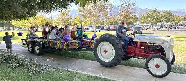 On Sunday, October 5th, St. Francis of Assisi Catholic Church celebrated its Annual Parish Fiesta from 10am to 5:30pm. The large crowd enjoyed live entertainment, bingo, loteria, kids’ games, raffle, a silent auction, and good food and drink. Pictured is the Stations of the Cross tractor ride. Inset, a happy fiesta goer. Photo credit: Fillmore Gazette Staff 