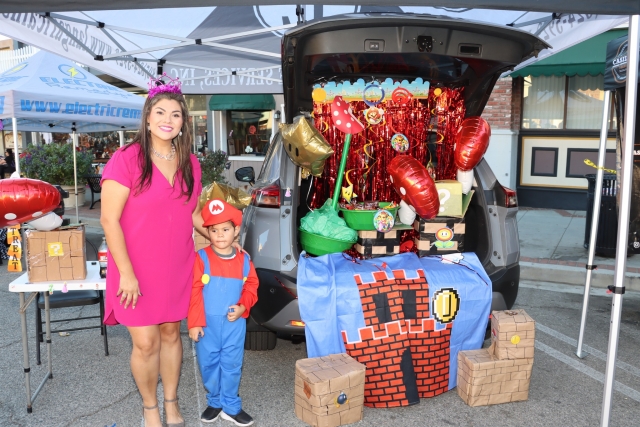 Fillmore’s Annual Trunk or Treat drew one of its largest crowds since its beginning. The City of Fillmore hosted the annual Halloween event this year on Tuesday, October 31st, from 6pm-8pm in Downtown Fillmore, on Central Avenue. Many groups/organizations/individuals handed out candy/treats from their decorated car “trunks”. It offered a safe, free trick or treating experience to all the ghosts, princesses and a Super Mario Brother, pictured above. Inset, Jack & Sally enjoying their Nightmare Before Christmas. Photo credit Angel Esquival-AE News.